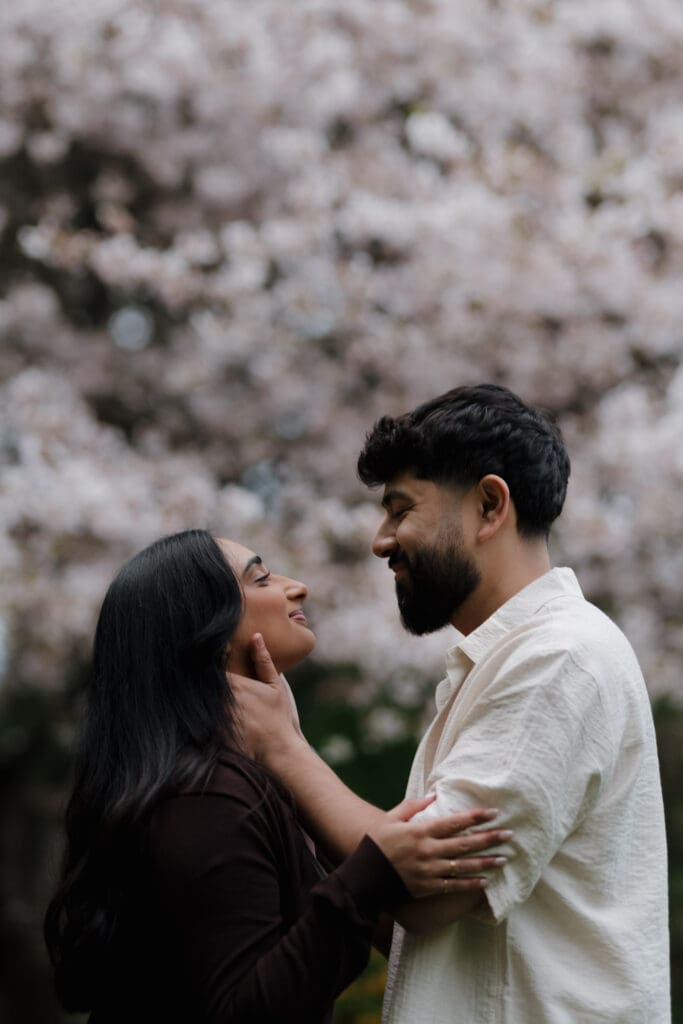 Candid emotional moment between Harwinder and Imran during surprise proposal shoot at Saxe Point Park, Victoria BC