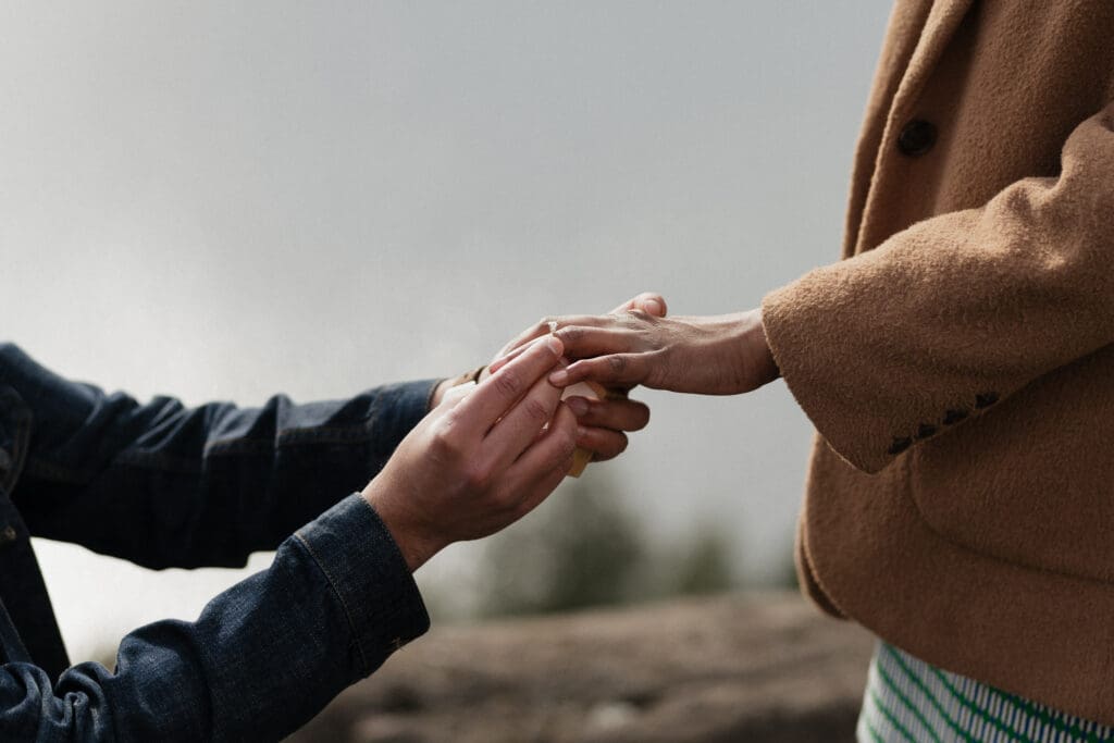 A surprise proposal is captured on Vancouver Island. We see the moment the male partner is placing the ring on the female partners hand.