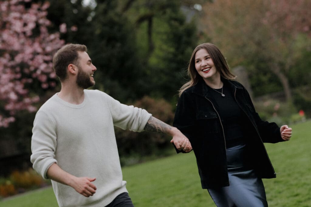 what to wear to your engagement photoshoot in victoria bc, tips from a local engagement photographer who captured two people at government house running in the grass