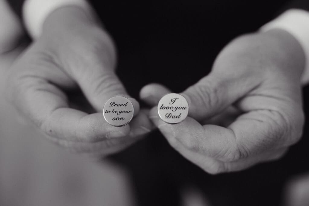The cufflinks of a groom gifts his Dad before his wedding in Honesdale PA. One reads "I love you Dad" and the other "Proud to be your son".