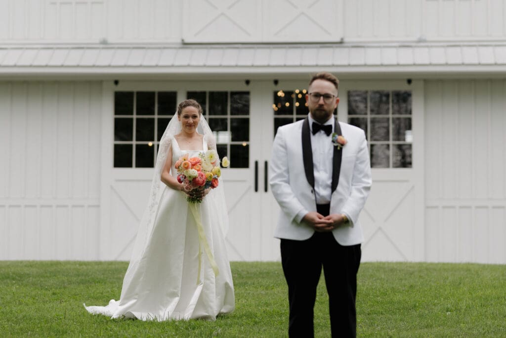 A bride waits for her groom to turn for their emotional first look at Wildflower on Watts in Honesdale PA.