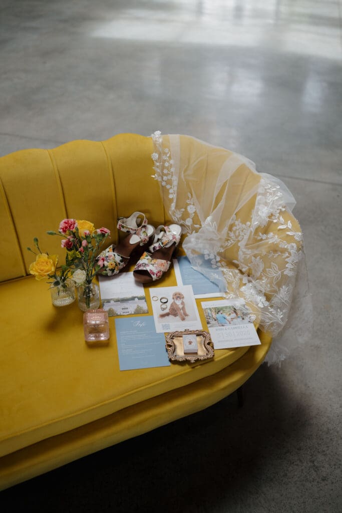 A bride's accessories arranged on a yellow couch at Wildflower on Watts in Honesdale PA.