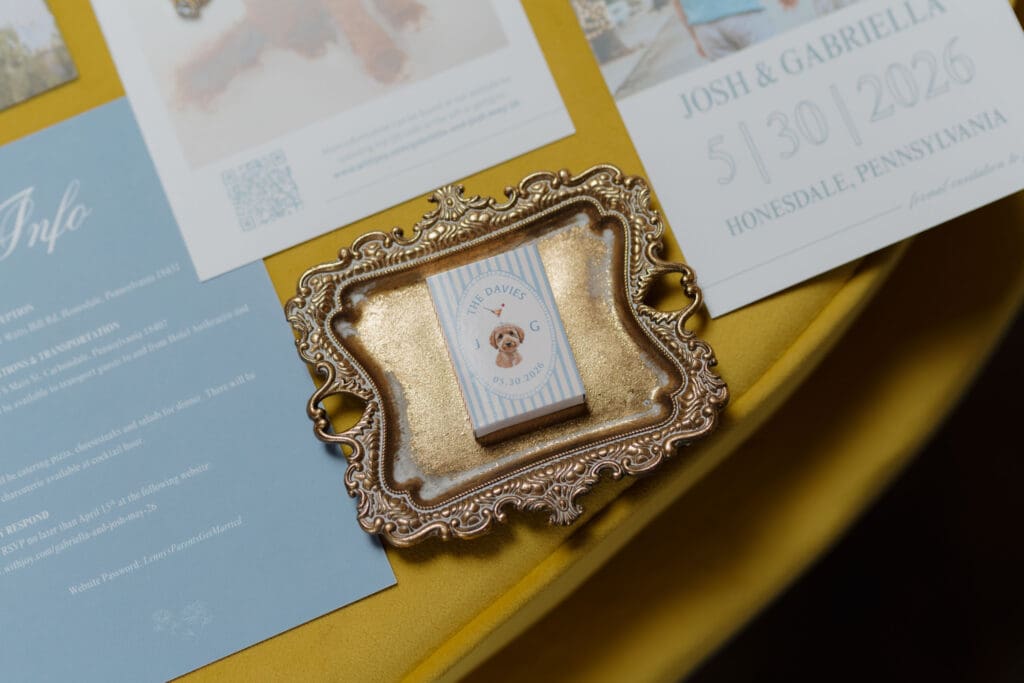 An image of a couple's puppy framed on a yellow couch captured before their wedding at Wildflower on Watts.
