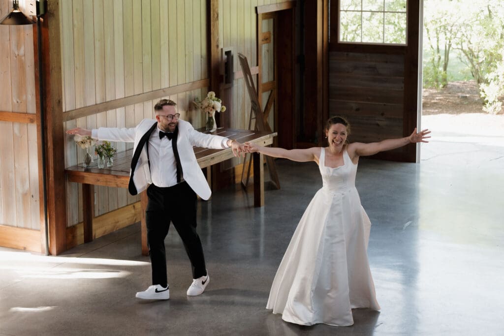 A newly married husband and wife enter the reception in grand, happy, fun style at Wildflower on Watts in Honesdale PA.