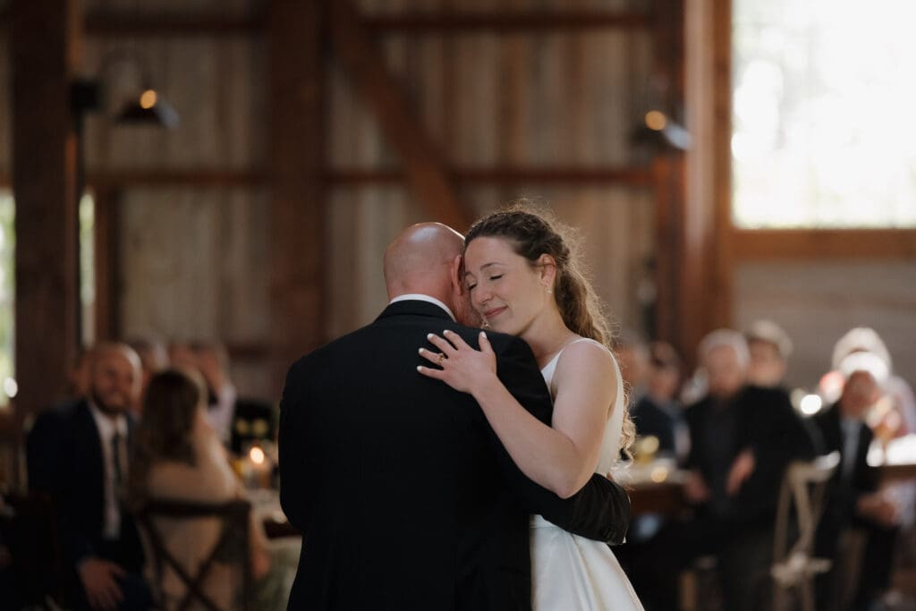 A bride shares an emotional dance with her Dad during their Father/Daughter dance at her wedding reception.