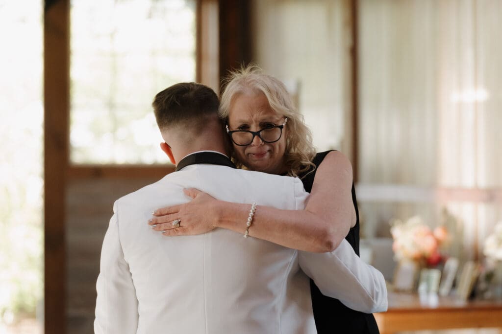 A groom and his Mom share a Mother/Son dance at the wedding reception held at Wildflower on Watts in Honesdale PA.