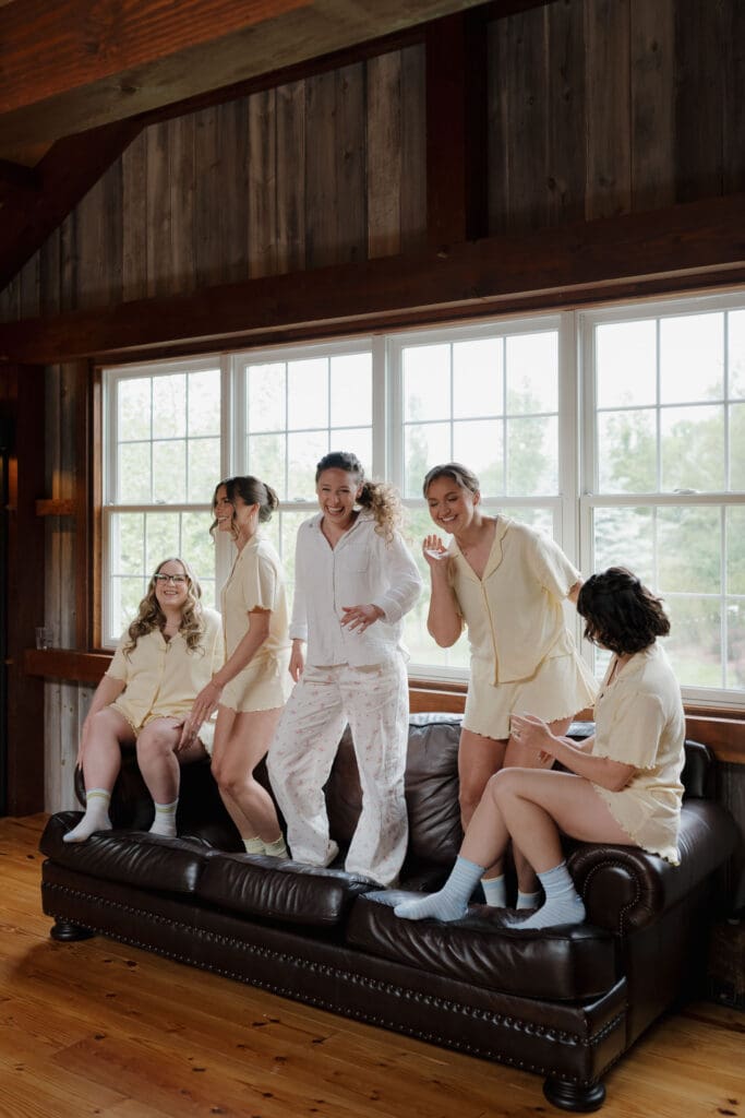 The bride and her bridesmaids have fun laughing and dancing pre wedding at Wildflower on Watts.