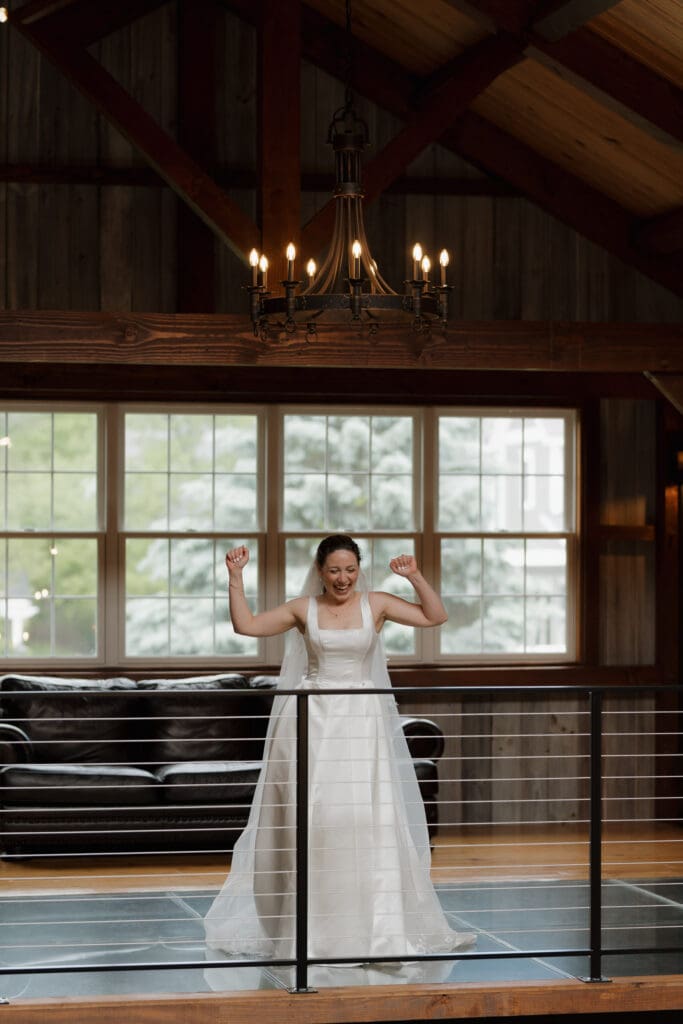 A bride to be waits for the first look with her father inside the barn at Wildflower on Watts in Honesdale PA. Captured by travel wedding photographer Hayley Zumkeller.
