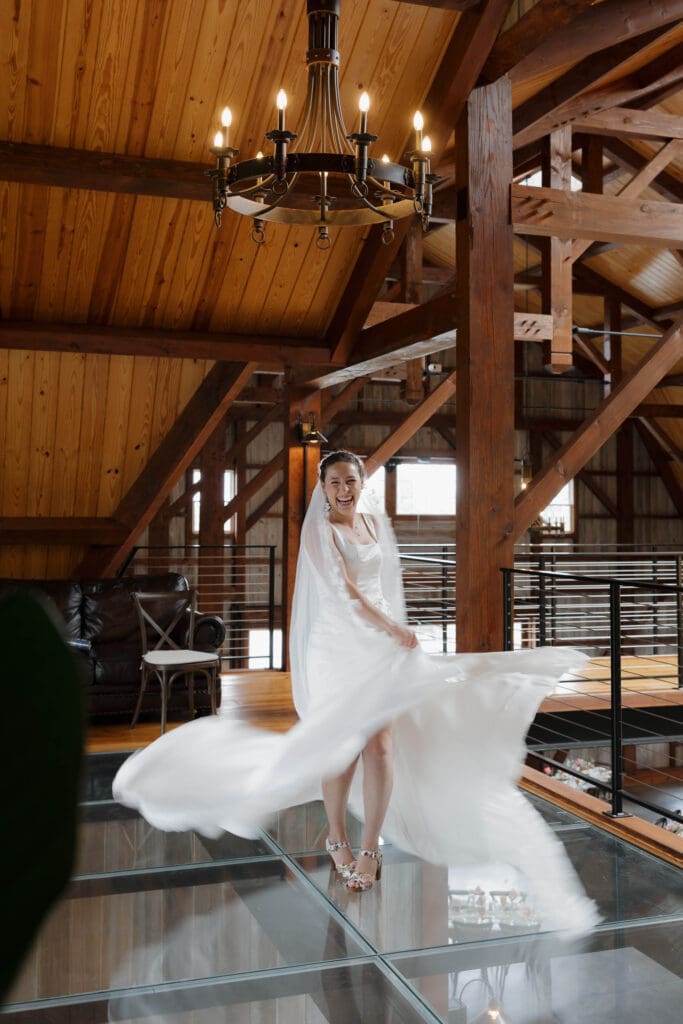 A bride to be twirls in her dress excitedly before the wedding at Wildflower on Watts in Honesdale PA.