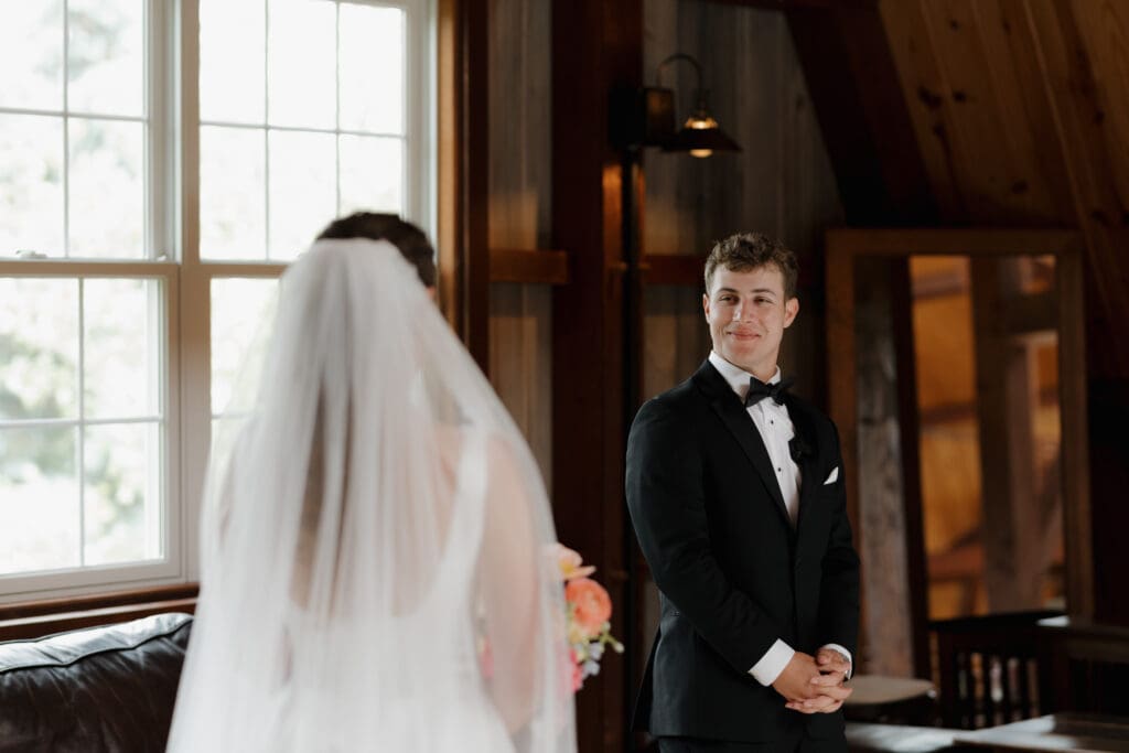 A sibling first look captured at Wildflower on Watts in Honesdale PA. The back of the bride is seen and her brother turning for the emotional first look.
