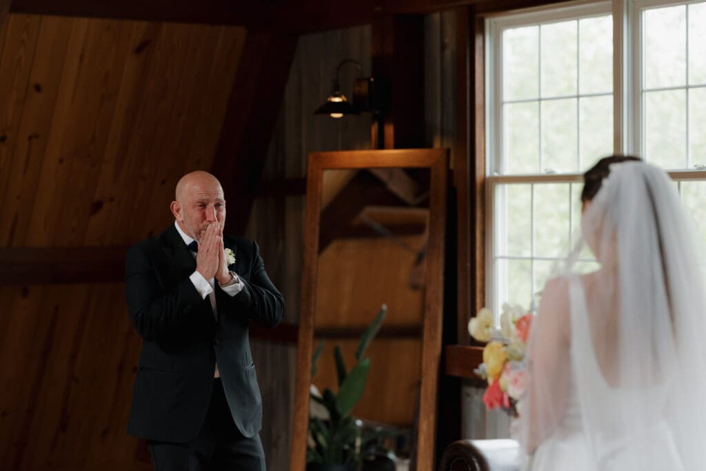 A father of the bride exclaims happily as he turns to see his daughter for their special father/daughter first look before her wedding in Honesdale PA.