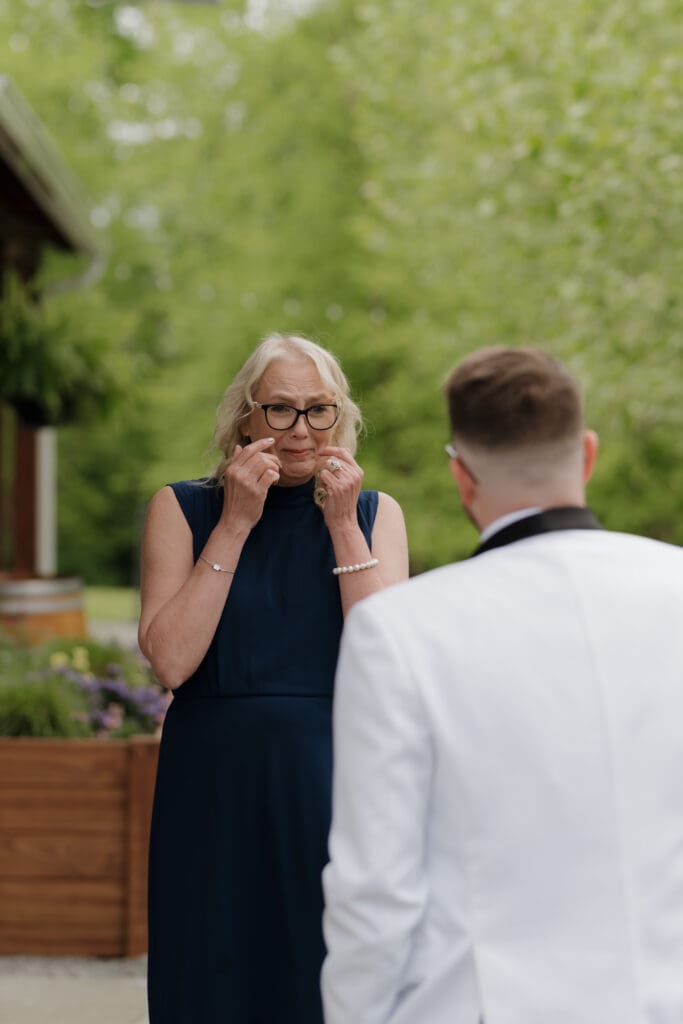 The mother of the groom stares emotionally at her son during their special mother/son first look at Wildflower on Watts in Honesdale PA