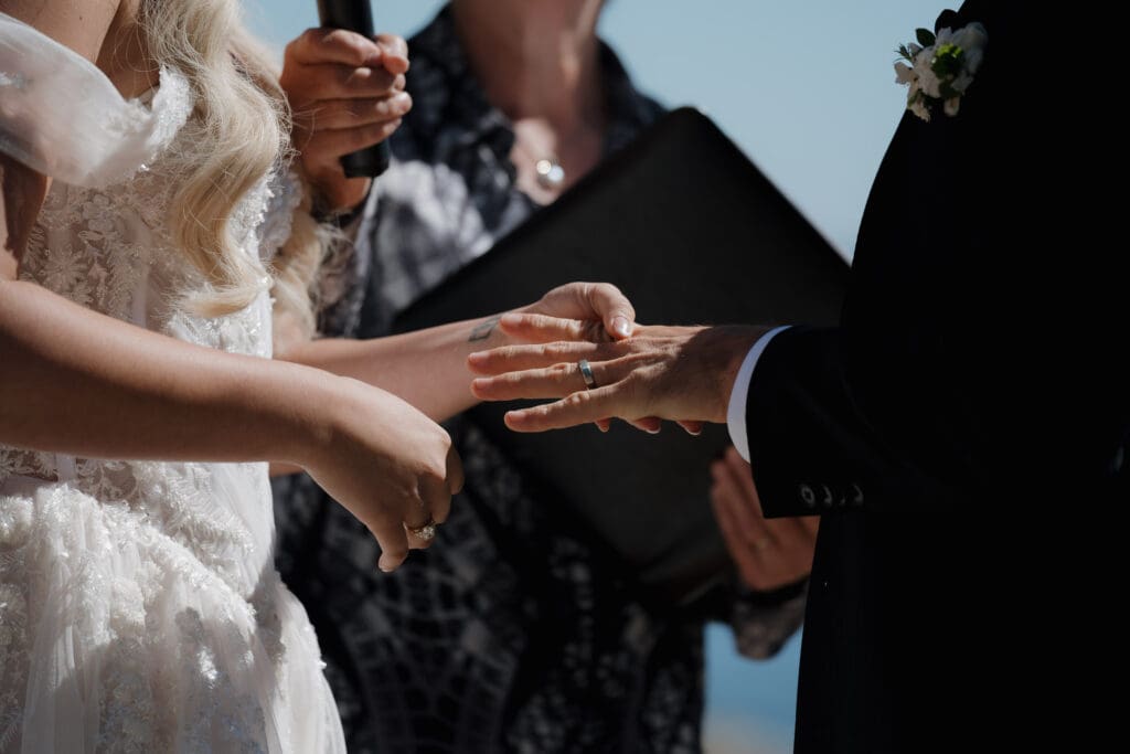 A ring exchange during a beach wedding at Chesterman Beach in Tofino BC captured by Victoria BC photography and videography team Hayley Zumkeller.