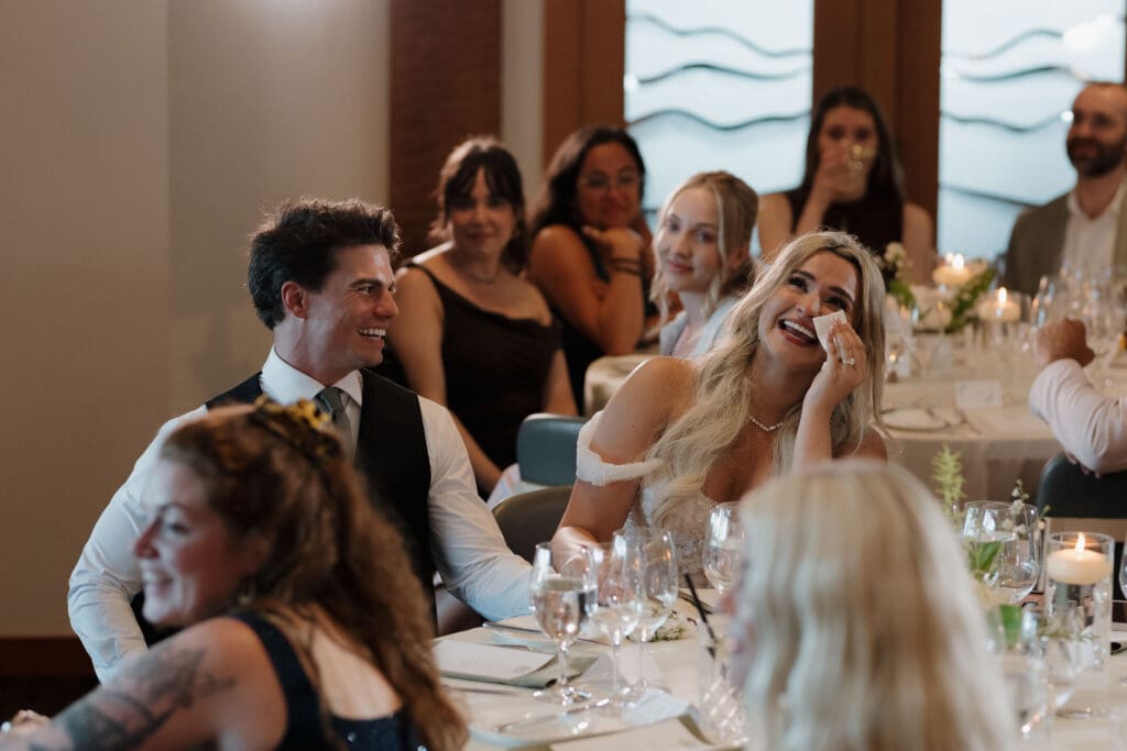 A bride and groom share an emotional moment during the speeches at their wedding ceremony.