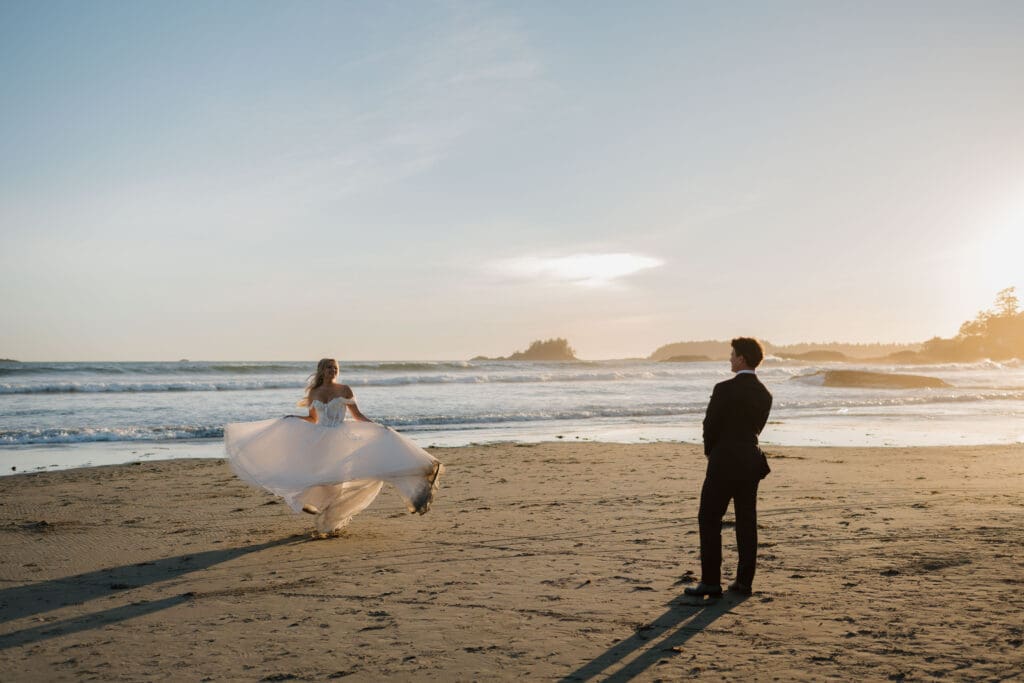 Newlyweds running along the Pacific Ocean during sunset wedding photos in Tofino BC