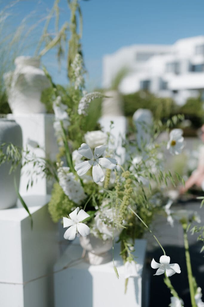 A white flower arrangement set up for a wedding ceremony at Inn on Laurel Point. 