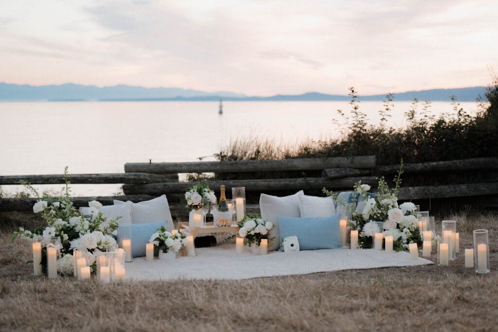 Candles and florals arranged for a private evening proposal in Victoria BC along Dallas Road
