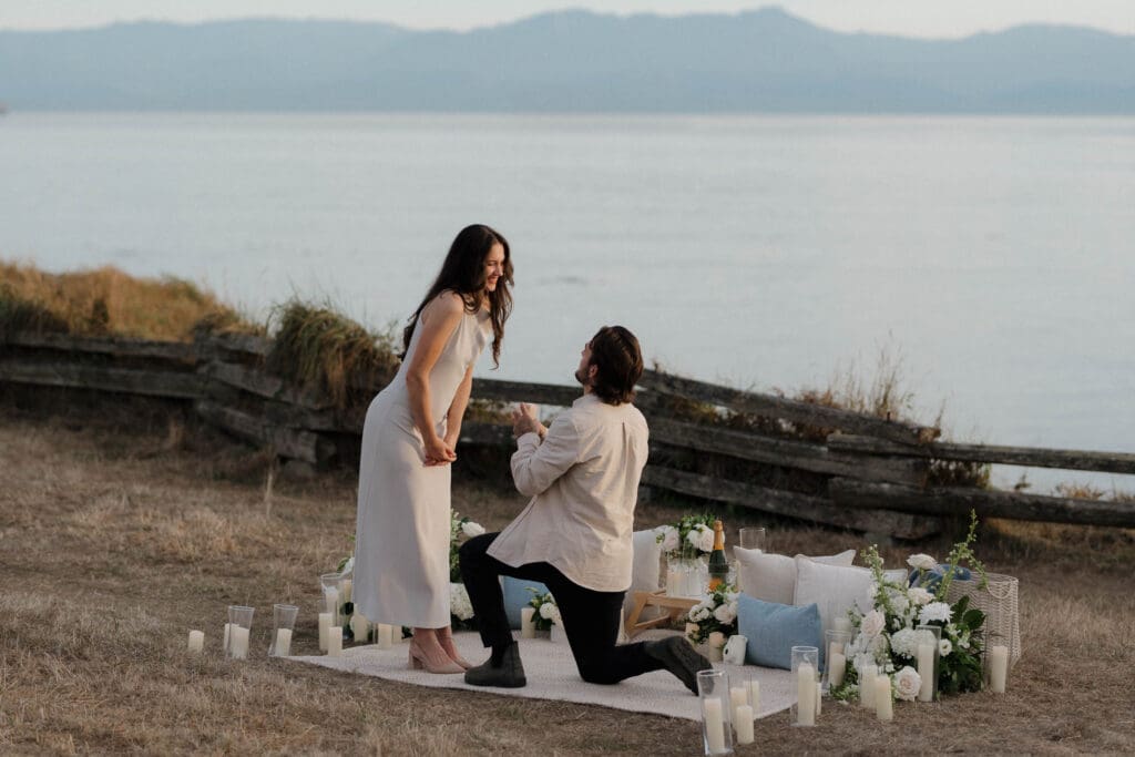 Couple celebrating with champagne after a candlelit surprise proposal in Victoria BC